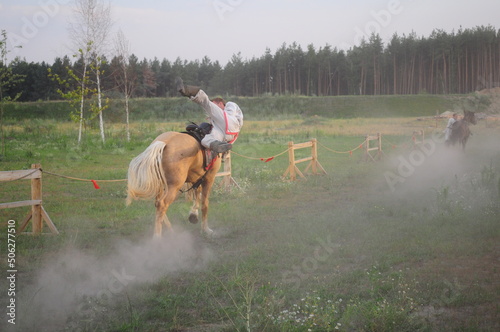 the rider performs in a traditional equestrian show on the occasion of the summer solstice in eastern europe. Tricks performed on the race. photo