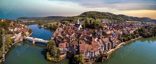 Fototapeta Naklejka Na Ścianę i Meble -  Romantic beuatiful paces of Switzerland . Laufenburg town over Rhein river. popular tourist destination, border with Germany. Aerial panoramic view over sunset