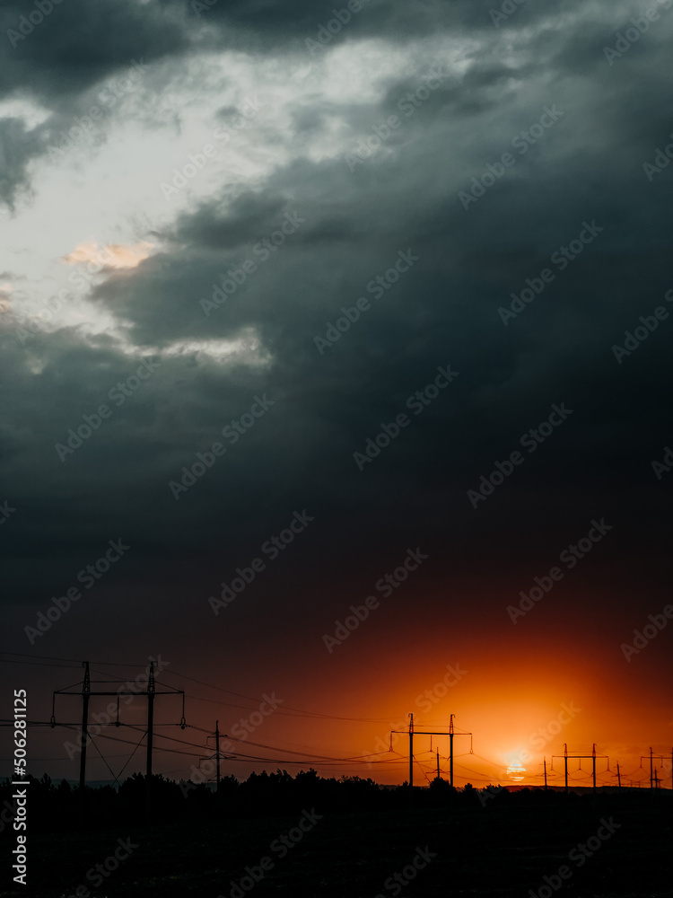 Dramatic stormy sky with orange amazing sunset gradient. Epic grey clouds, beautiful nature background, before thunder