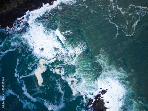 Top view of the ocean waves. Colorful swirl of water. Minimalism. Abstraction. There is no one in the photo. Ecology, water sports, recreation, tourism, travel. Marine background.