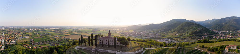 Panoramic Aerial footage view from the drone of a ancient fortress built on a green hill