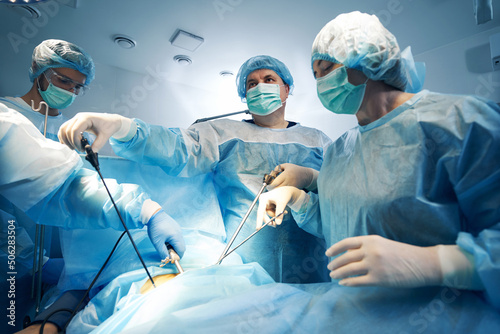 Canvastavla Specialist in surgery using laparoscopic tools while operating on patient