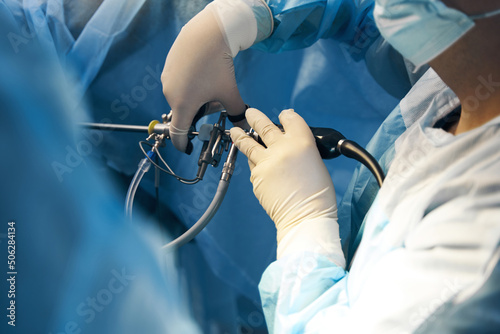 Hand of surgeon holding laparoscopic equipment for minimally invasive surgery photo