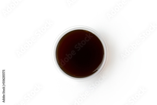 Small plastic bottle with soy sauce isolated on white