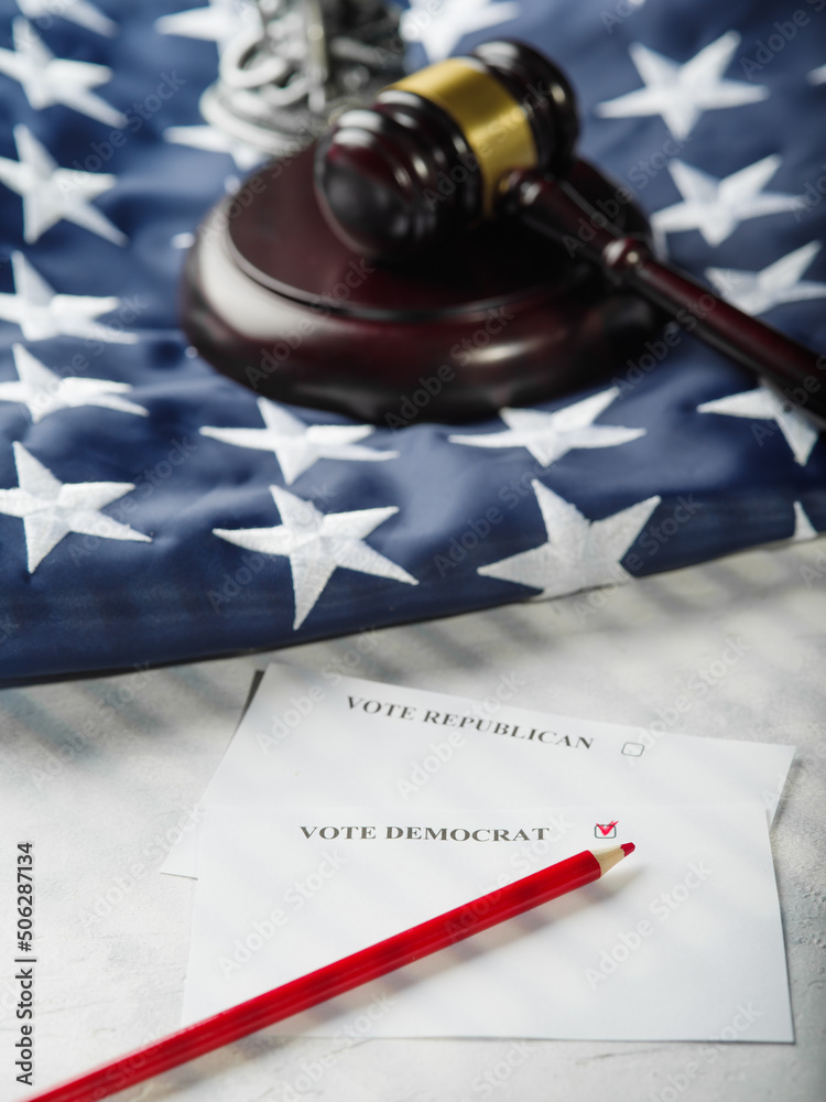 An American flag, a judge's gavel, and a leaflet calling for votes for Republicans and Democrats. The right to choose, freedom of choice, the constitutional right of a US citizen.
