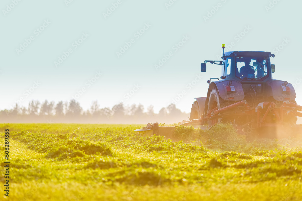 tractor makes harvesting hay for animals on a farm tractor makes harvesting hay for animals on a farm