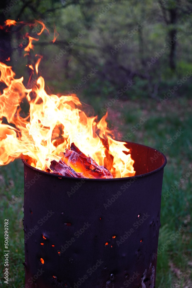 Flames spreading out from a fire
metal barrel Flames spreading out from a fire
metal barrel