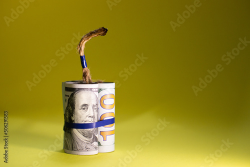 dynamite with money dollars on a yellow background