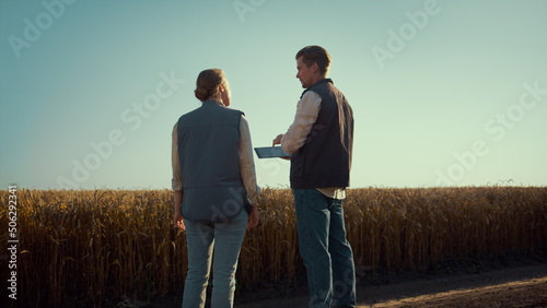 Photos Agronomist team discussing field works rear view