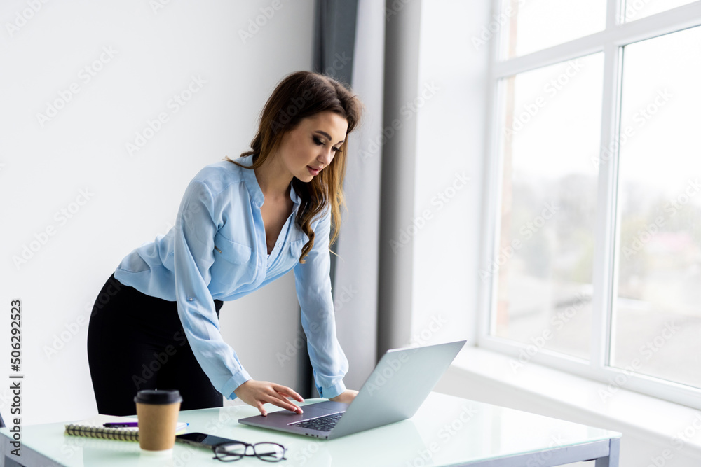 Young pretty woman working at lap top in the office. Young pretty woman working at lap top in the office.