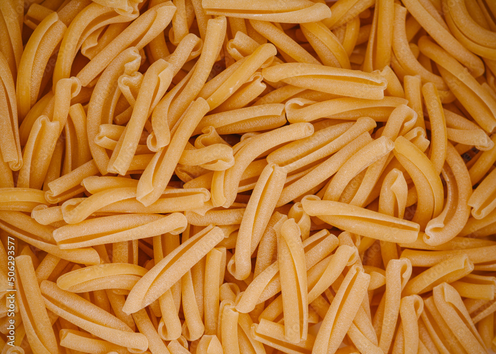 uncooked dry Italian pasta strozzapreti background uncooked dry Italian pasta strozzapreti background