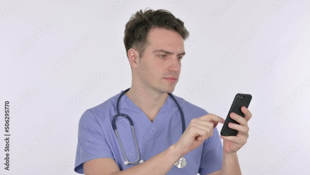Young Doctor Browsing Smartphone on White Background Young Doctor Browsing Smartphone on White Background