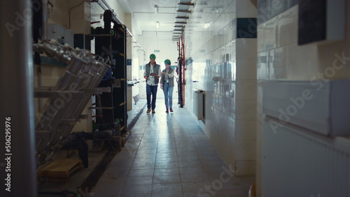 Wallpaper Mural Factory engineers walking production facility. Supervisors discuss milking plans Torontodigital.ca