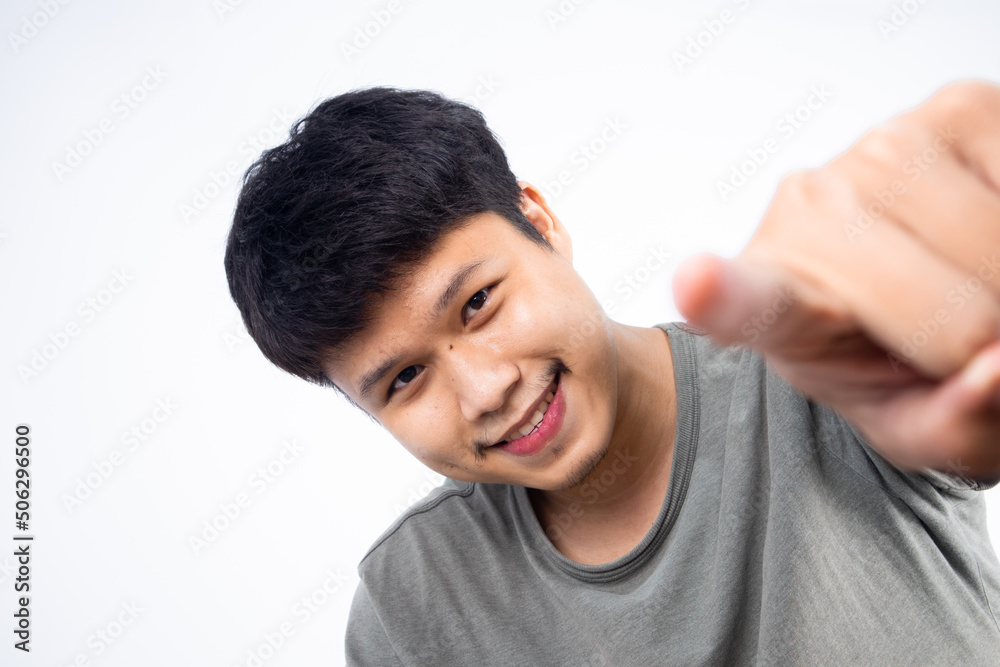 Asian man with dimple pointing at camera having fun and enjoying life Asian man with dimple pointing at camera having fun and enjoying life