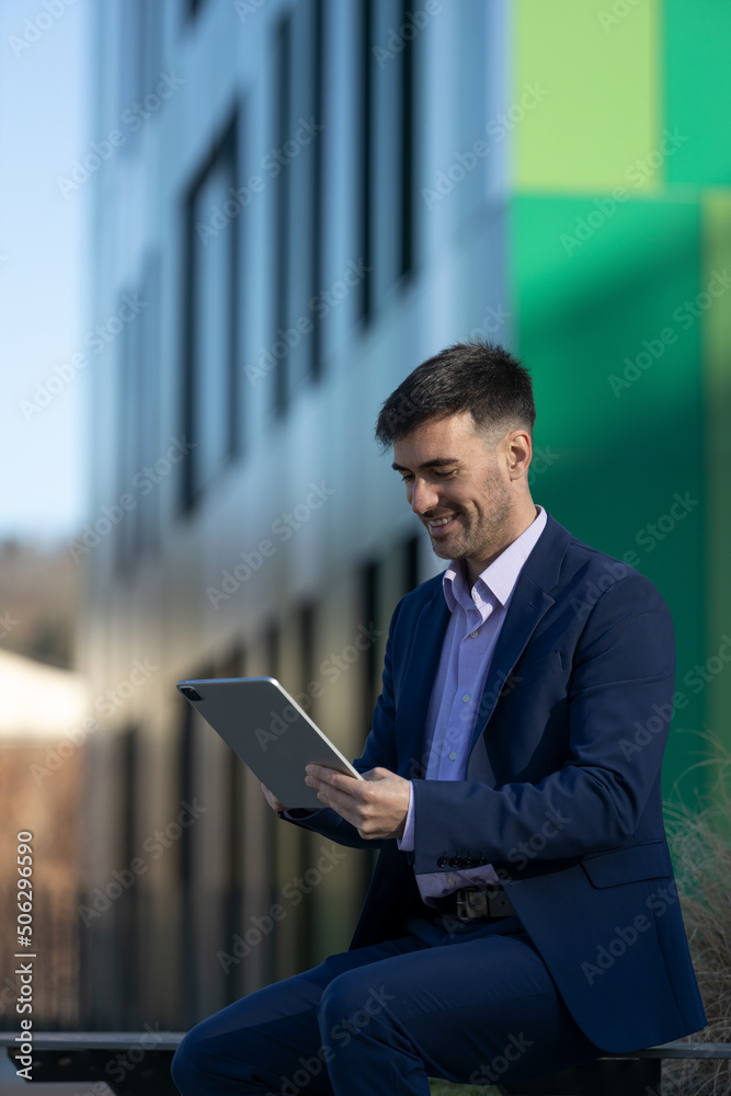 Close-up view of a business man with a tablet smiling