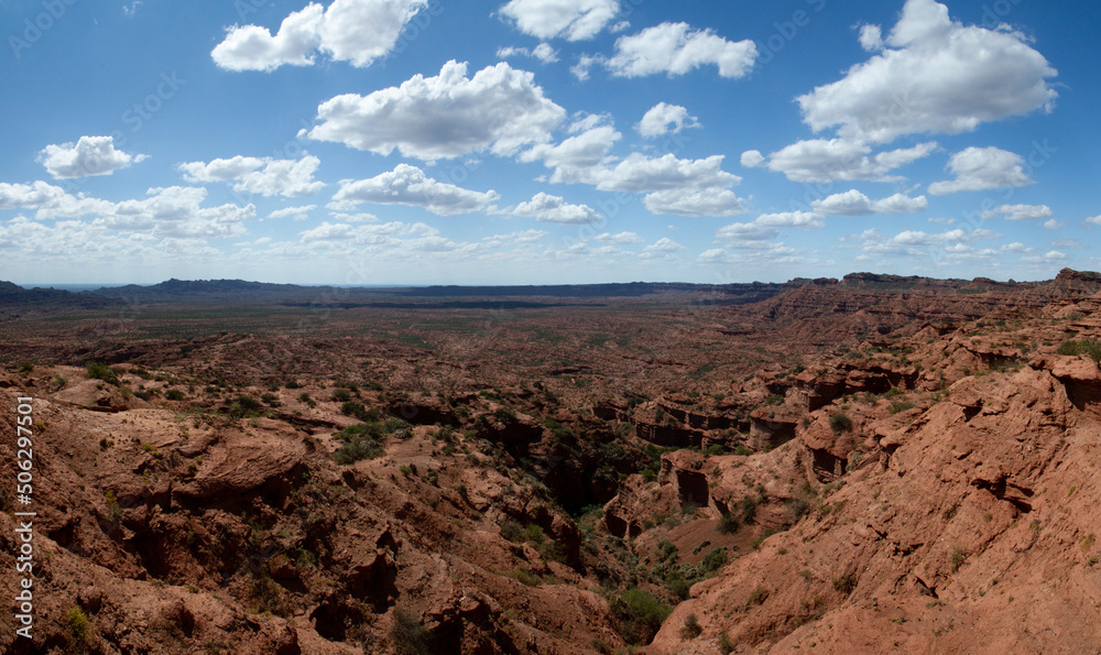 Desert landscape. Panorama view of the red sandstone and rock formations, cliffs, mountains and valley in Sierra de las Quijadas national park.
