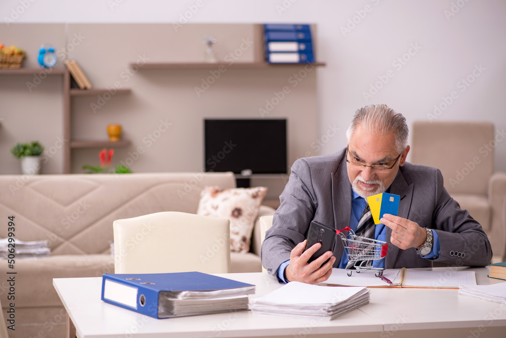 Old male employee in e-commerce concept during pandemic Old male employee in e-commerce concept during pandemic