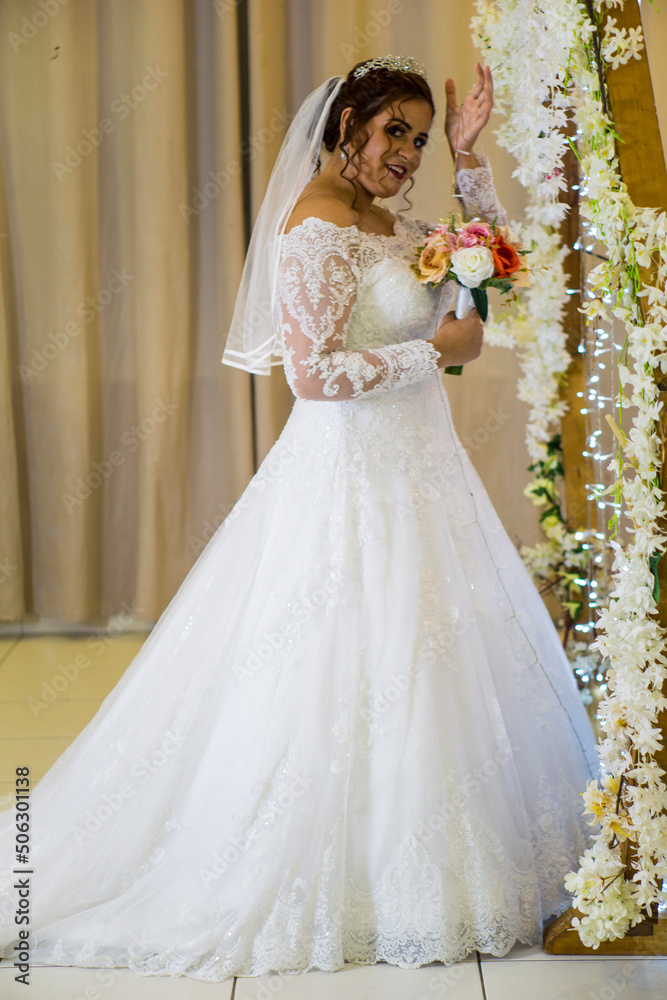 plus size young caucasian brazilian bride at her wedding with decorated background, makeup and hairstyle. plus size young caucasian brazilian bride at her wedding with decorated background, makeup and hairstyle.