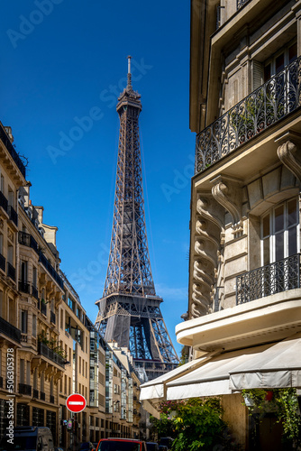 Paris, France - May 27, 2021: Eiffel tower between haussman buildings in Paris