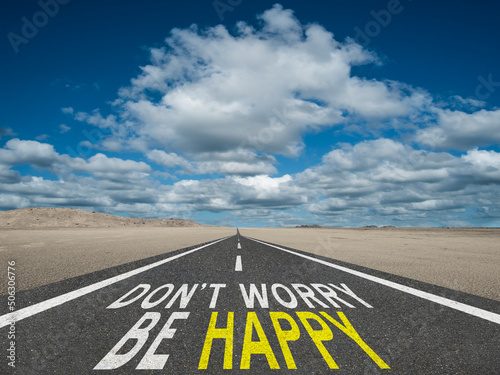 Don't Worry Be Happy motivational quote on highway and nature background.