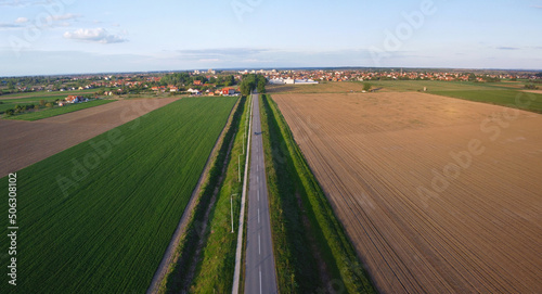 Aerial photography of road and arable crop land for wheat sunflower or corn in Serbia