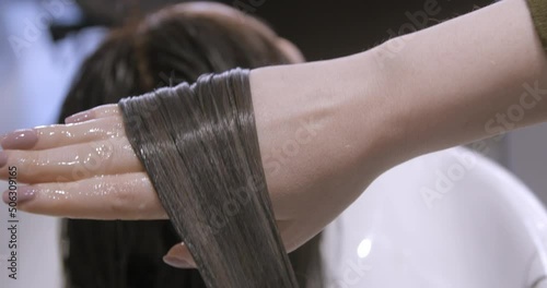 Hairdressing close-up with brunette woman, coloration, cut, brushing