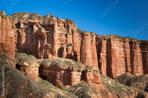 Bright orange rocks of the Binggou Danxia canyon, blue sky with copy space for text, Zhangye, Gansu, China