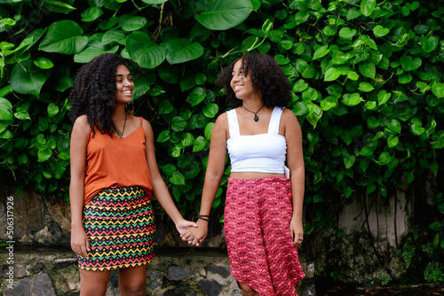 Happy lesbian couple holding hands in the park