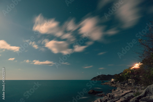 Fototapeta Naklejka Na Ścianę i Meble -  Full moon rising over sea and rocks on the beach
