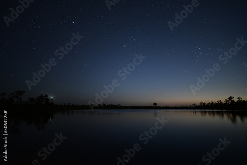 Stars at twilight over Pine Glades Lake in Everglades National Park, Florida on clear April evening.
