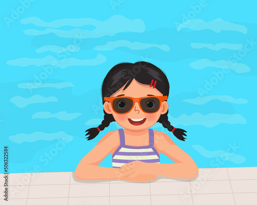 cute little girl in swimsuit and sunglasses having fun on swimming pool in summertime