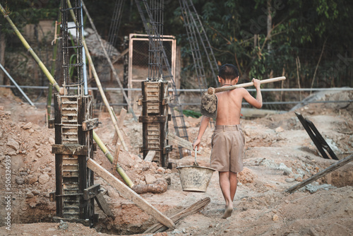 Poor children at the construction site were forced to work. Concept against child labor. The oppression or intimidation of forced labor among children. Human trafficking.