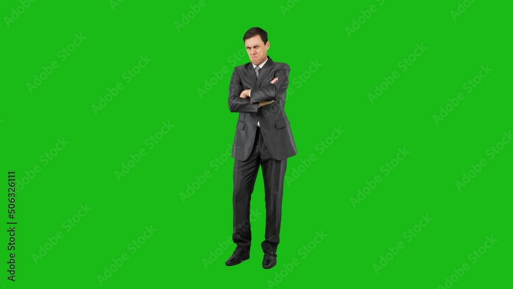 Self confident man watching over in elegant suit. Green background. Self confident man watching over in elegant suit. Green background.