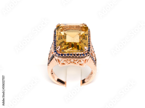 Citrine with Blue Sapphire ring on white background. Collection of natural gemstones accessories. Studio shot