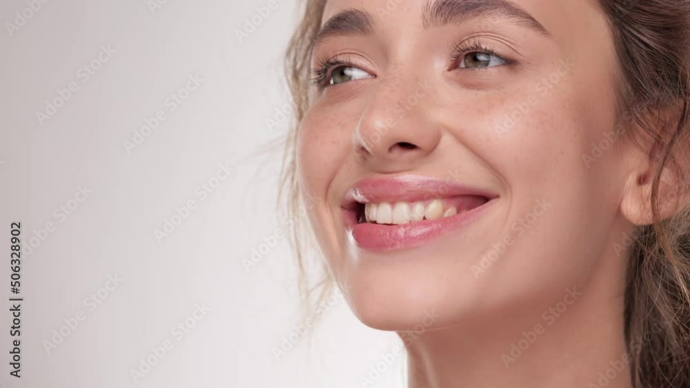 Girl paints her lips with a lip brush. Caucasian model doing make-up. Woman makes makeup. Cosmetic and Skin care concept. Natural healthy face. Beauty treatment on white isolate background. Girl paints her lips with a lip brush. Caucasian model doing make-up. Woman makes makeup. Cosmetic and Skin care concept. Natural healthy face. Beauty treatment on white isolate background.
