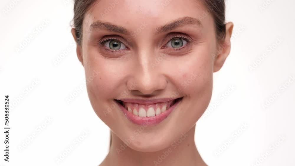 Concept for fresh moisturized elasticity skin. Close up Portrait of beautiful young female massaging and touching her face after applying cream. Natural healthy face. slow motion. Concept for fresh moisturized elasticity skin. Close up Portrait of beautiful young female massaging and touching her face after applying cream. Natural healthy face. slow motion.