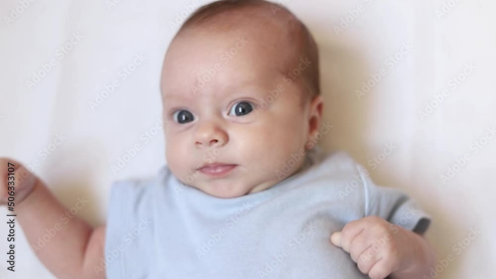 Video portrait of a baby toddler on a white background . Happy baby. A happy child. An infant looks into the camera . White background. High quality FullHD footage Video portrait of a baby toddler on a white background . Happy baby. A happy child. An infant looks into the camera . White background. High quality FullHD footage