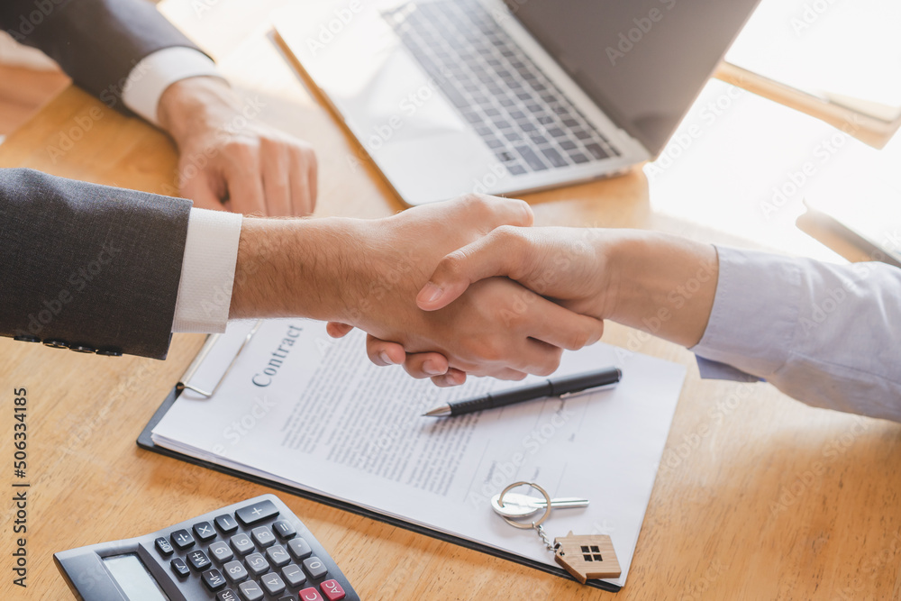 Fototapeta premium Close up hand of asian young male new landlord, tenant or rental handshake with home, apartment agent or realtor man after bank approved mortgage, loan signed purchase contract. Property of financial.