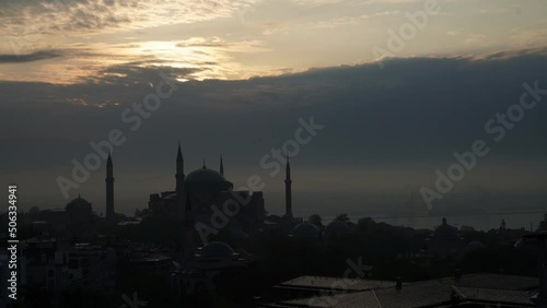 Hagia Sophia and Blue Mosque timelapse at night reflected in Bosphorus water. View from asian part of the city near madens tower. Istanbul, Turkey