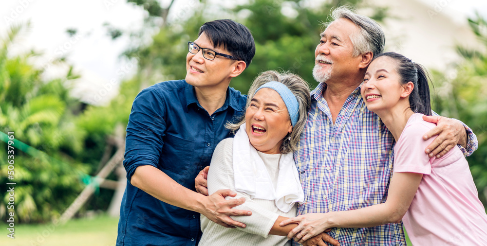 Obraz premium Portrait enjoy happy smiling love multi-generation asian big hug family.Senior mature father and elderly mother with young adult woman and son outdoor in park at home.insurance concept