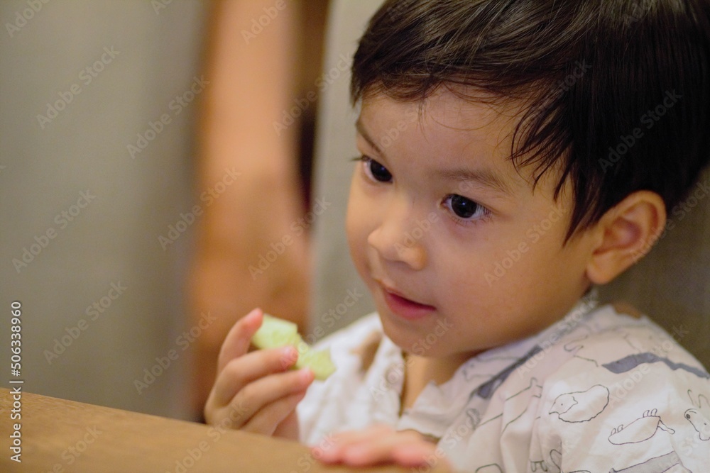 appy little Asian todler boy at dining table.Happy chld appy little Asian todler boy at dining table.Happy chld