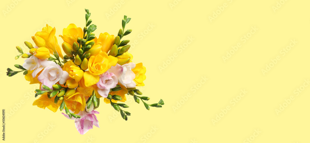 Bouquet of beautiful freesia flowers on yellow background, space for text. Banner design