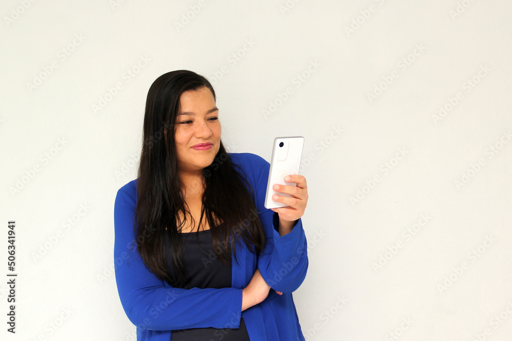 Latin adult woman with straight black hair and a blue jacket sends and receives messages from her cell phone very excited and happy makes purchases online in app
Latin adult woman with straight black hair and a blue jacket sends and receives messages from her cell phone very excited and happy makes purchases online in app