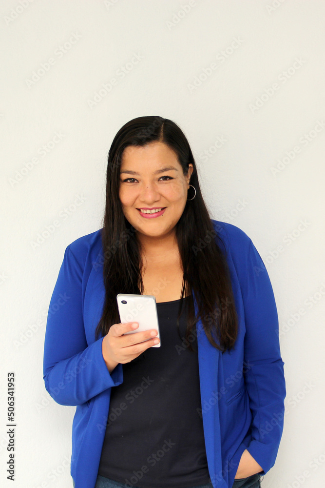 Latin adult woman with straight black hair and a blue jacket sends and receives messages from her cell phone very excited and happy makes purchases online in app
Latin adult woman with straight black hair and a blue jacket sends and receives messages from her cell phone very excited and happy makes purchases online in app
