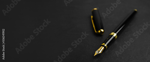 Tableau sur toile Beautiful fountain pen with ornate nib on black table, closeup view with space for text