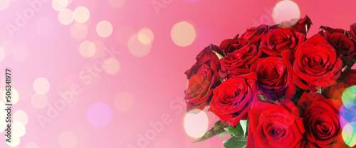 Bouquet of beautiful red roses on pink background  space for text. Banner design