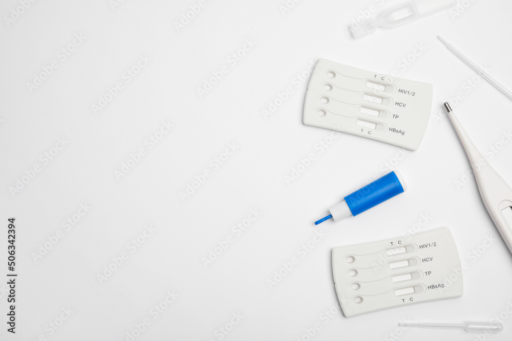 Disposable express hepatitis test kit on white background, flat lay. Space for text Disposable express hepatitis test kit on white background, flat lay. Space for text