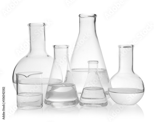 Laboratory glassware with transparent liquid on white background