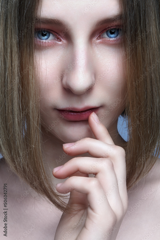 Close-up portrait of beautiful young woman with blond hair covering her face. Close-up portrait of beautiful young woman with blond hair covering her face.