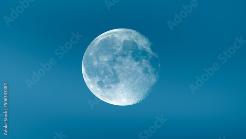 Full white Moon with blue sky  Elements of this image furnished by NASA  